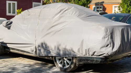 Many Cars Parked Near Suburban Home Driveway Covered With Protec